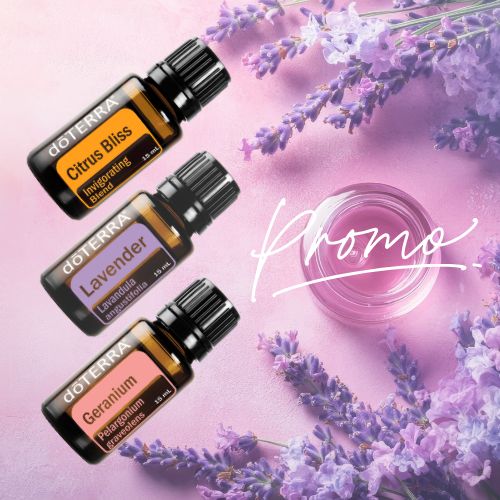 doTERRA essential oil bottles with lavender flowers on a pink background