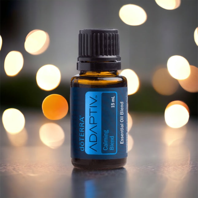 doterra adaptiv essential oil blend with a minimilistic background and gold lights