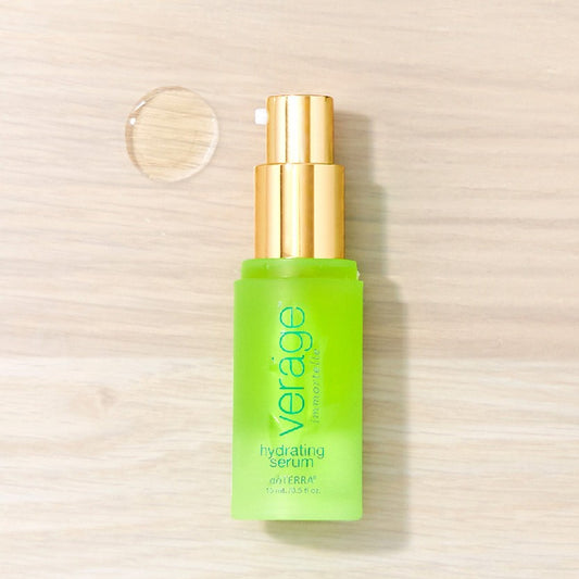 Green serum bottle with gold cap on a light wooden background