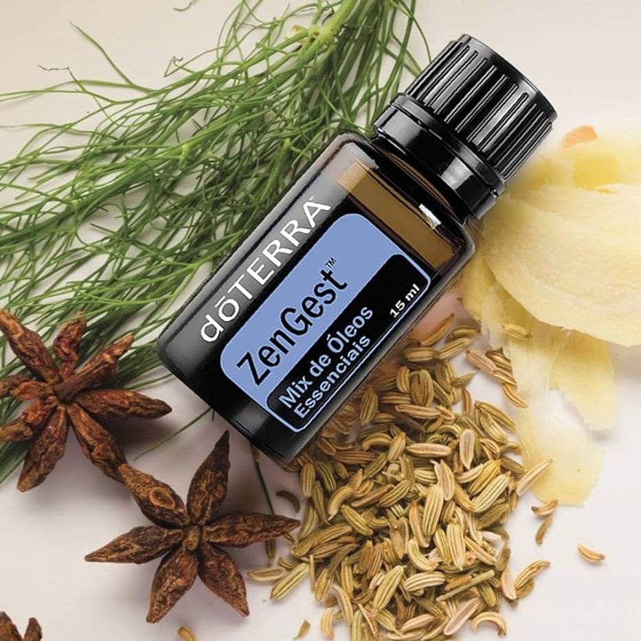 doTERRA ZenGest essential oil bottle surrounded by herbs and spices on a light background