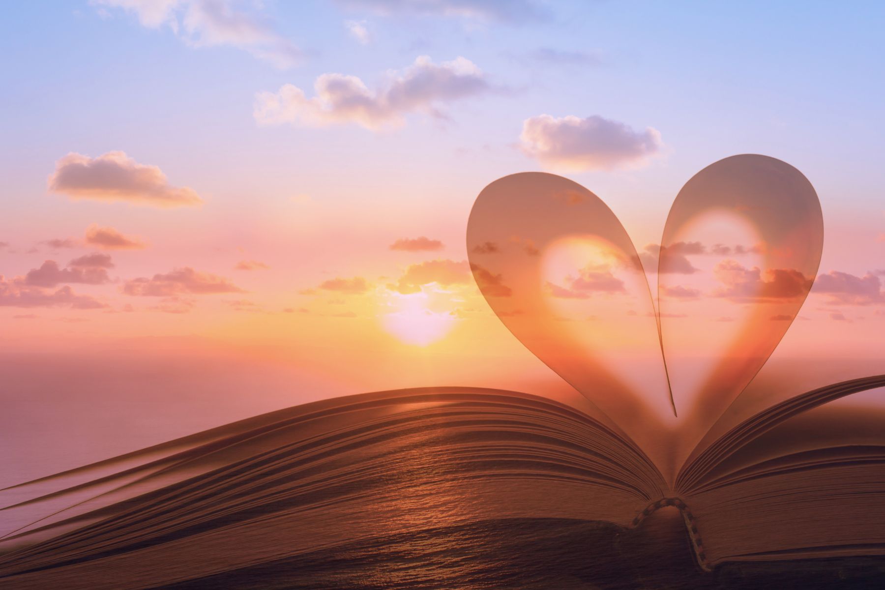 Heart emerging from an open book with a beautiful sunset – Symbolizing wisdom, wellness, and heart-centered healing