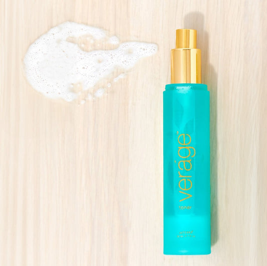 Blue bottle with gold cap labeled 'verage' on a beige background