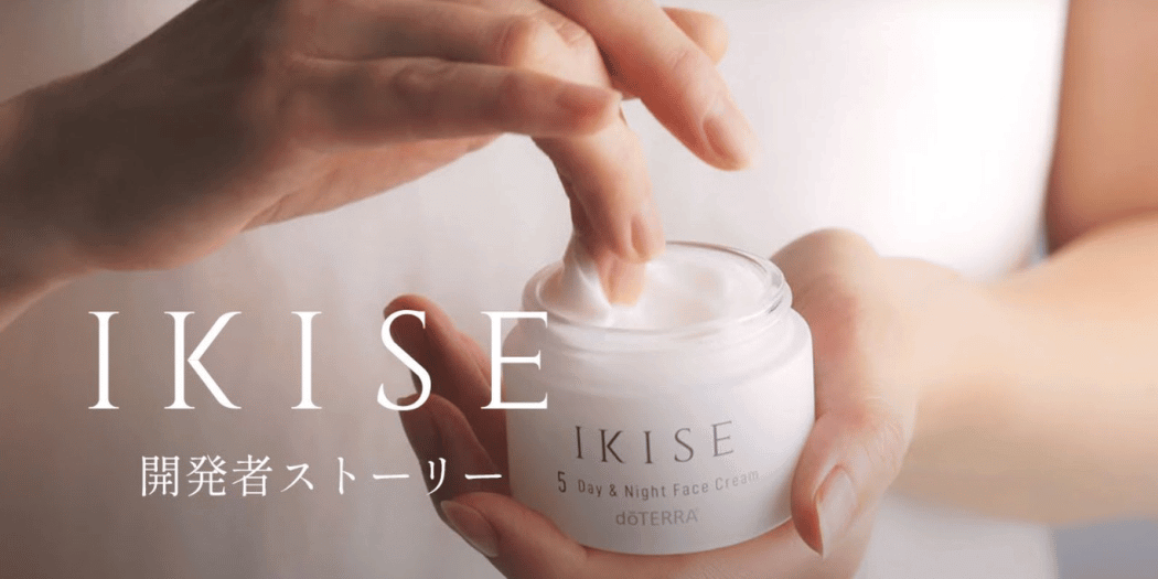 Person holding a jar of IKISE skincare product with a blurred background