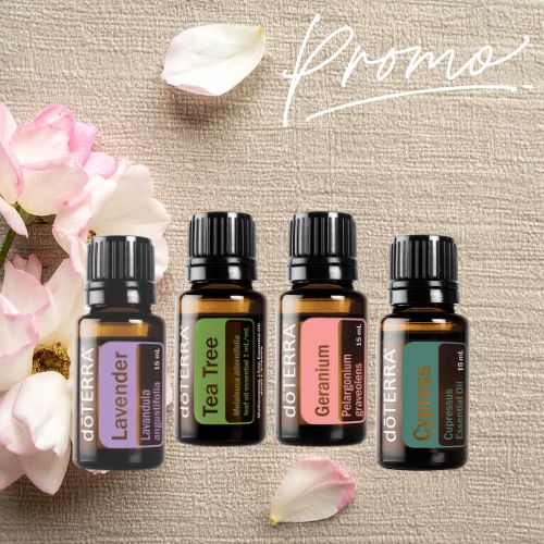 Four doTERRA essential oil bottles with flowers on a textured surface