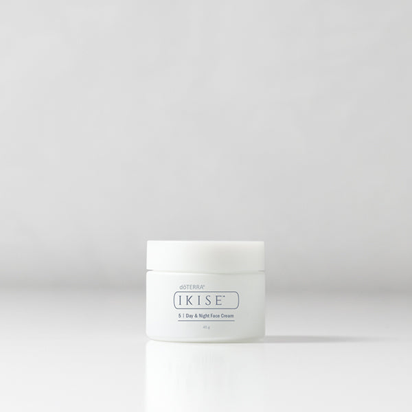 White jar of ikise cream on a light gray background