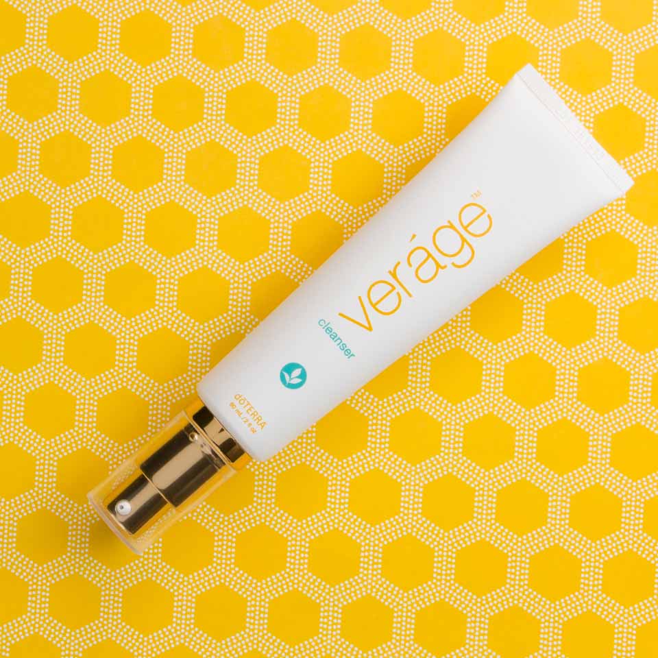 Tube of 'verage' cleanser on a yellow hexagonal patterned background