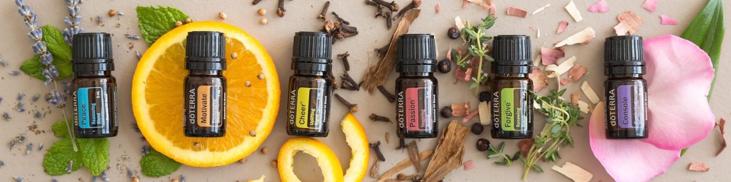 Essential oil bottles with botanical elements on a light background