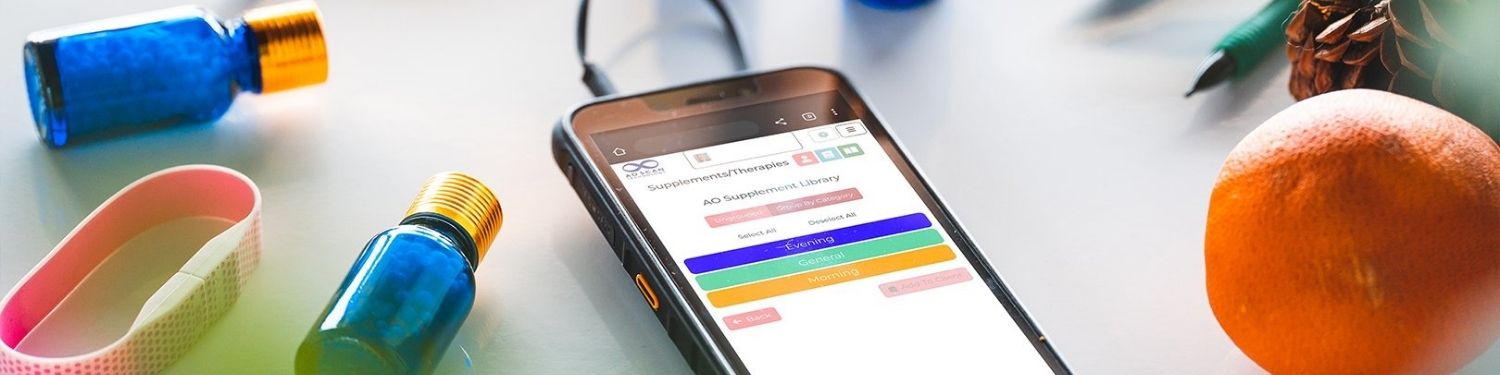 Smartphone displaying a fitness app on a desk with health and wellness items.
