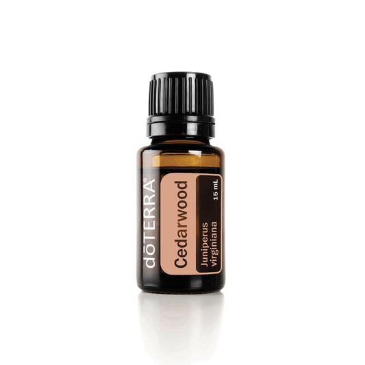 A bottle of doTERRA Cedarwood essential oil on a white background.